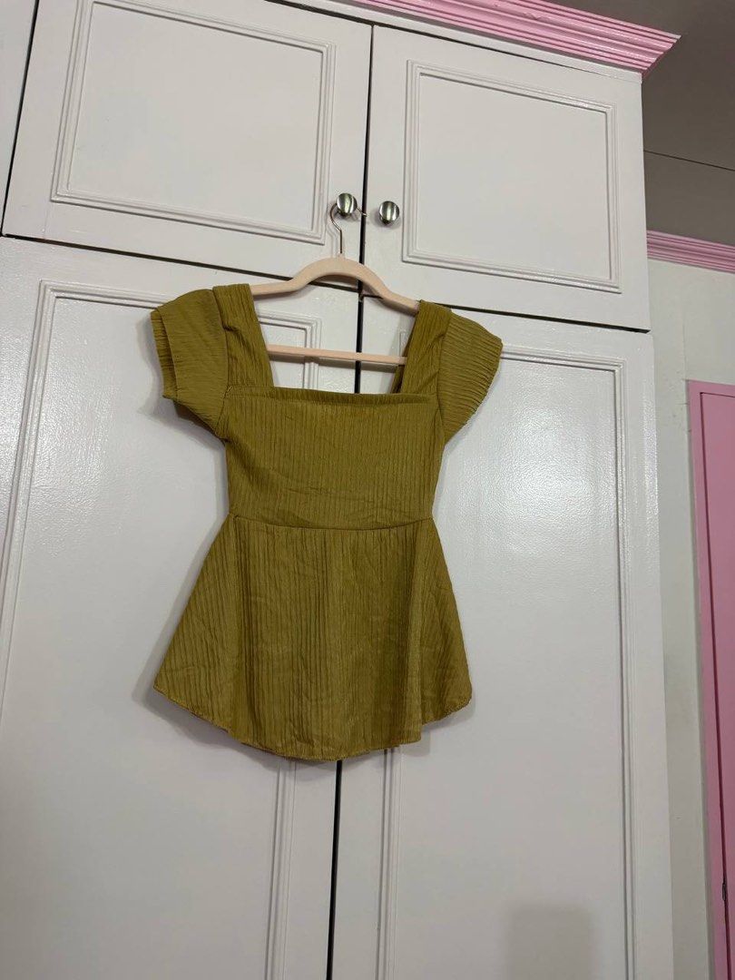 Olive Green Square Neck Bow Peplum Top (Category: Blouses) located in Quezon City. Submitted by patzyy (Listing ID 1461603318, Image 2). Description: - Chic olive green top - Flattering square neckline - Adorable bow detail at the front - Stylish peplum hemline - Delicate short flutter sleeves - Textured fabric for added interest - Versatile: pairs perfectly with jeans or skirts.