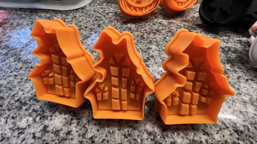 Orange Halloween House Cookie Cutters Set (Category: Bakeware) located in Makati City. Submitted by esila.essentials (Listing ID 1461788780, Image 1). Description: - Set of 3 orange cookie cutters - Shaped like haunted houses - Perfect for Halloween baking - Detailed window and brick designs - Great for making fun, festive treats.