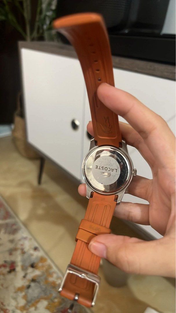 Original Lacoste Watch Orange Strap (Category: Women's Watches) located in Muntinlupa City. Submitted by trendeemoodshop2022 (Listing ID 1461585060, Image 2). Description: - Authentic Lacoste watch - Vibrant orange strap - Sleek black dial with striking red accents - Convenient date window at 3 o'clock - Durable stainless steel case - Water resistant up to 50 meters (5 ATM) - Ideal for everyday wear and casual styling - Selling as it's no longer 