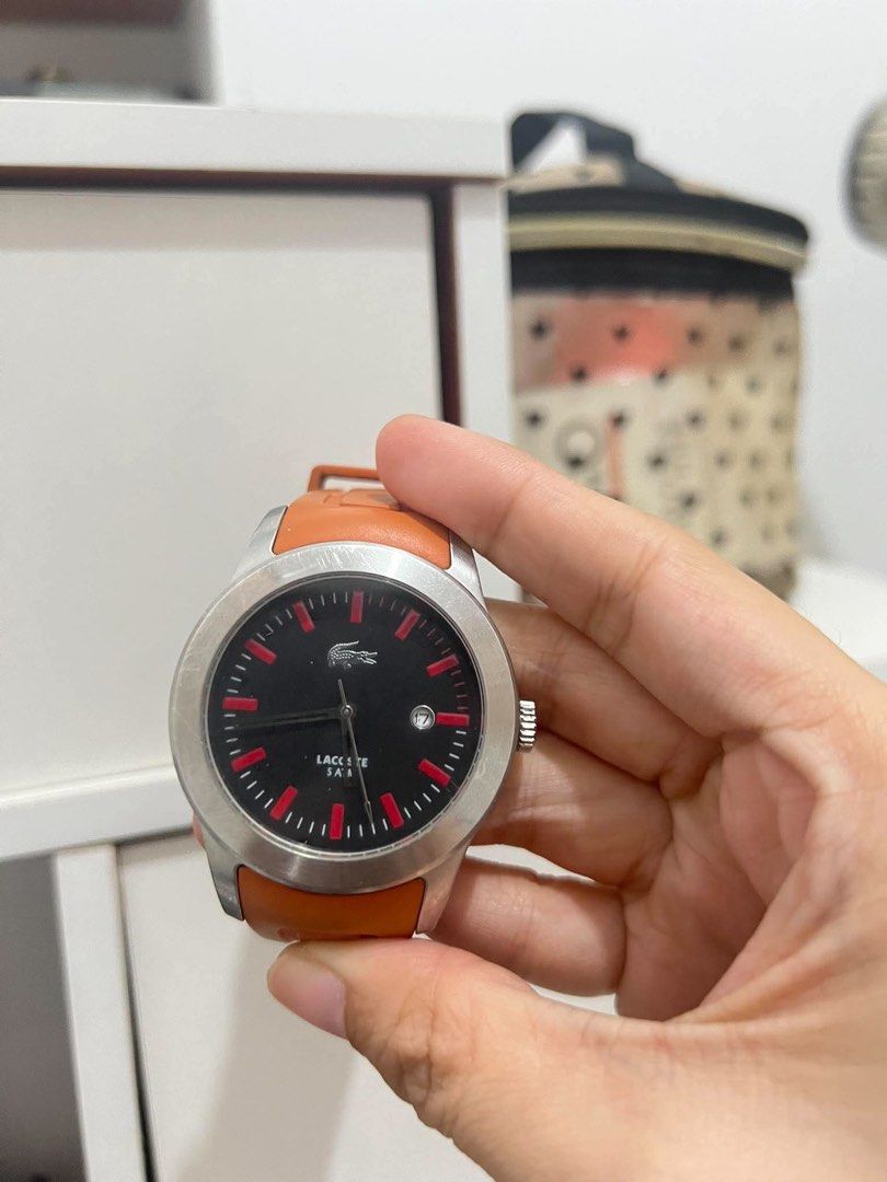 Original Lacoste Watch Orange Strap (Category: Women's Watches) located in Muntinlupa City. Submitted by trendeemoodshop2022 (Listing ID 1461585060, Image 1). Description: - Authentic Lacoste watch - Vibrant orange strap - Sleek black dial with striking red accents - Convenient date window at 3 o'clock - Durable stainless steel case - Water resistant up to 50 meters (5 ATM) - Ideal for everyday wear and casual styling - Selling as it's no longer 