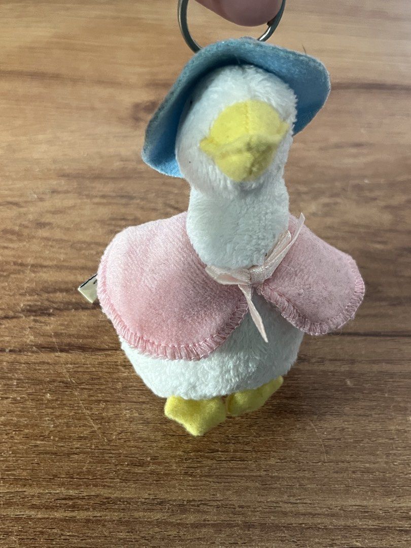 Original Peter Rabbit Plush Duck Keychain with Hat and Cape (Category: Plushies & Soft Toys) located in Gapan. Submitted by lunashop14 (Listing ID 1461614136, Image 2). Description: - Adorable Peter Rabbit plush duck keychain - Features a cute blue hat and a pink cape tied with a ribbon - Bright yellow feet and beak - Made by Frederick Warne & Co. in 2008 - Ideal accessory for your bags or keys.