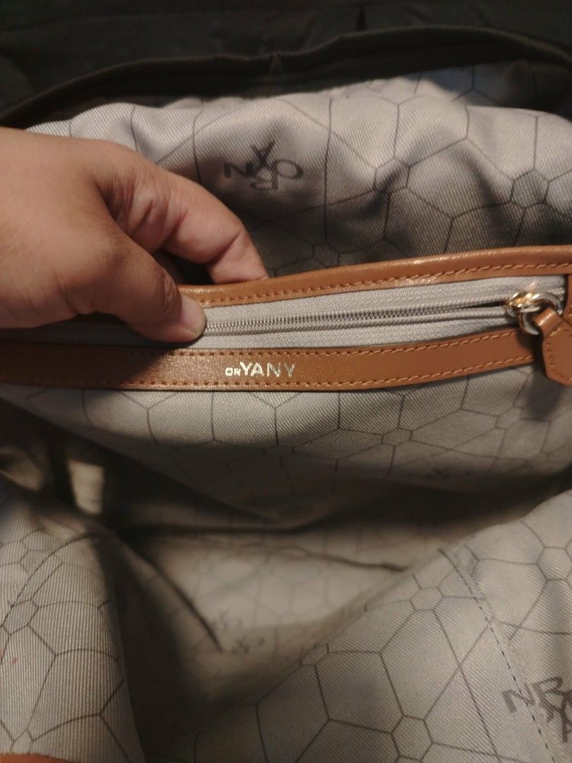ORYANY Black Nylon Backpack with Tan Leather Accents (Category: Backpacks) located in Manila. Submitted by wildwind_73f77a (Listing ID 1461584402, Image 2). Description: - ORYANY black nylon backpack - Tan leather trim on front zip pocket and base - Interior lining with geometric pattern - Adjustable shoulder straps - Ideal for everyday use or travel.