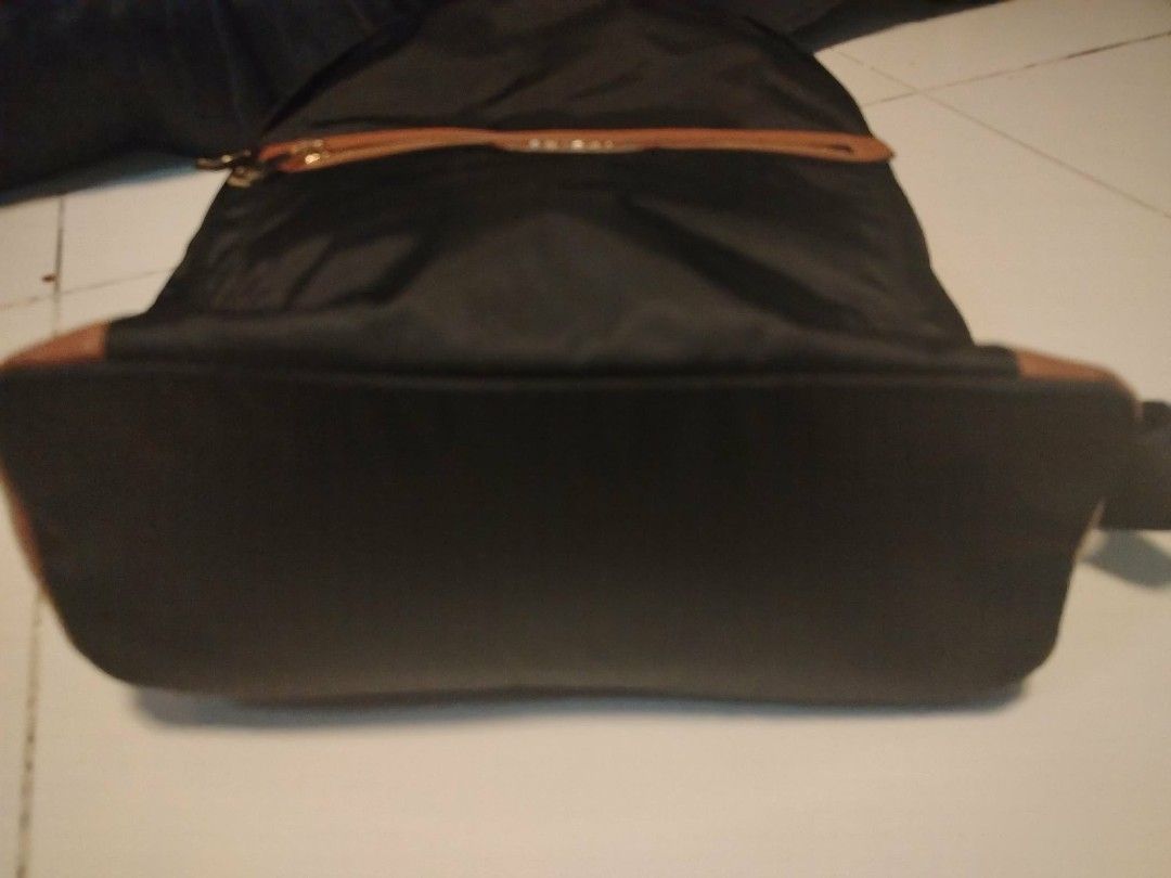 ORYANY Black Nylon Backpack with Tan Leather Accents (Category: Backpacks) located in Manila. Submitted by wildwind_73f77a (Listing ID 1461584402, Image 3). Description: - ORYANY black nylon backpack - Tan leather trim on front zip pocket and base - Interior lining with geometric pattern - Adjustable shoulder straps - Ideal for everyday use or travel.