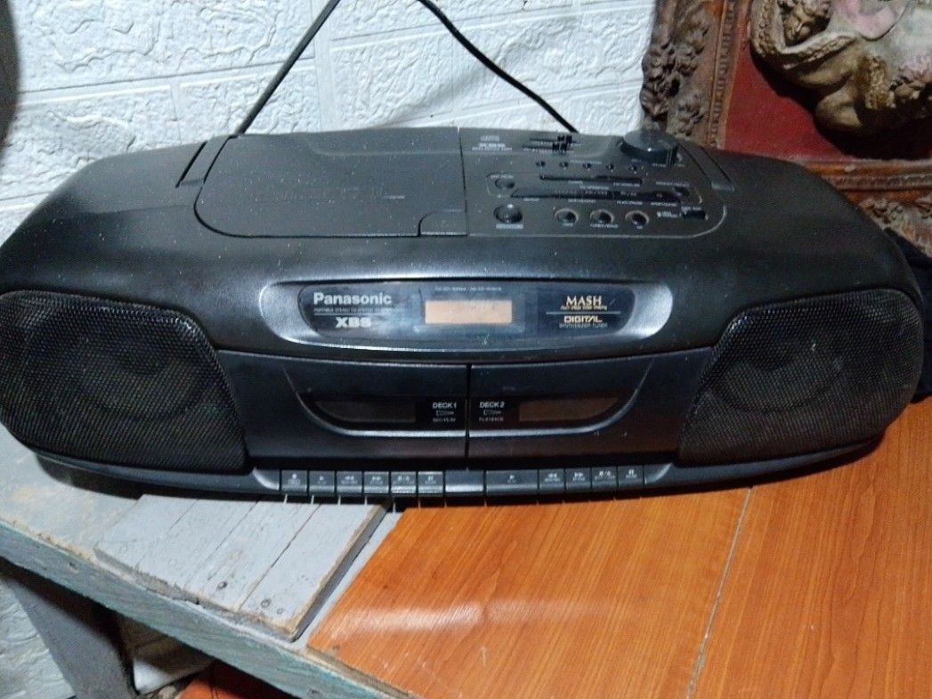 Panasonic boombox (Category: Vinyls) located in Quezon City. Submitted by mhond-ray192512 (Listing ID 1461438635, Image 1). Description: Vintage Panasonic RX-DT401 portable stereo boombox good condition. XBS (Extra Bass System) for enhanced low-frequency sound. MASH Digital synthesizer tuner for AM/FM radio. Dual cassette decks supporting tape playback and recording. Top-loading CD player compartment under the lid..