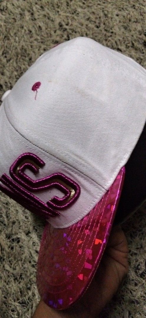 Phoenix Suns unisex NBA Snapback Cap White Pink Sparkle (Category: Caps & Hats) located in Paranaque City. Submitted by michael-08 (Listing ID 1461619151, Image 3). Description: - White snapback cap - Pink sparkle brim - 'SUNS' embroidered in gold and pink on the front - NBA logo on the side - Phoenix Suns logo on the back - Adjustable strap for a custom fit - Perfect for Phoenix Suns fans! UNISEX PO AUTHENTIC.WALA PO ISSUE GOOD CONDITION LIKE A 