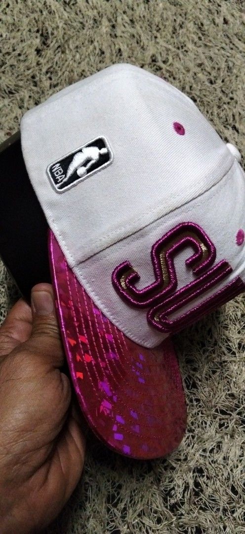 Phoenix Suns unisex NBA Snapback Cap White Pink Sparkle (Category: Caps & Hats) located in Paranaque City. Submitted by michael-08 (Listing ID 1461619151, Image 2). Description: - White snapback cap - Pink sparkle brim - 'SUNS' embroidered in gold and pink on the front - NBA logo on the side - Phoenix Suns logo on the back - Adjustable strap for a custom fit - Perfect for Phoenix Suns fans! UNISEX PO AUTHENTIC.WALA PO ISSUE GOOD CONDITION LIKE A 