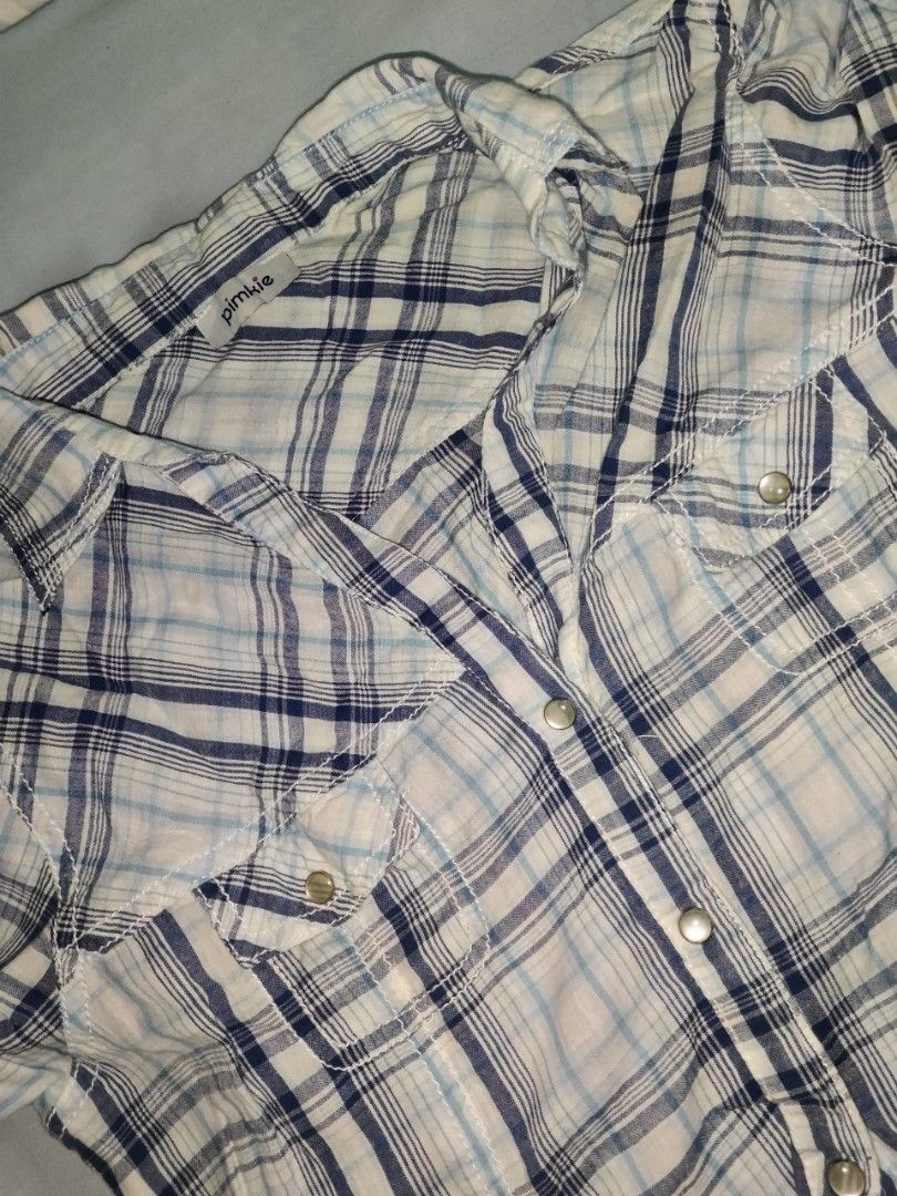 Pimkie Plaid Button-Up Shirt (Category: Shirts) located in Quezon. Submitted by strawberry_me (Listing ID 1461667824, Image 2). Description: - Cute blue and white plaid shirt from Pimkie - Short sleeves - Button-up front - Two chest pockets with button closures - Lightweight and comfortable fabric - Perfect for casual wear ‼️ STRICTLY: • No cancellation of orders • No return, no refund • No bogus buyers 💸 MODE OF PAYMENT: GCash.