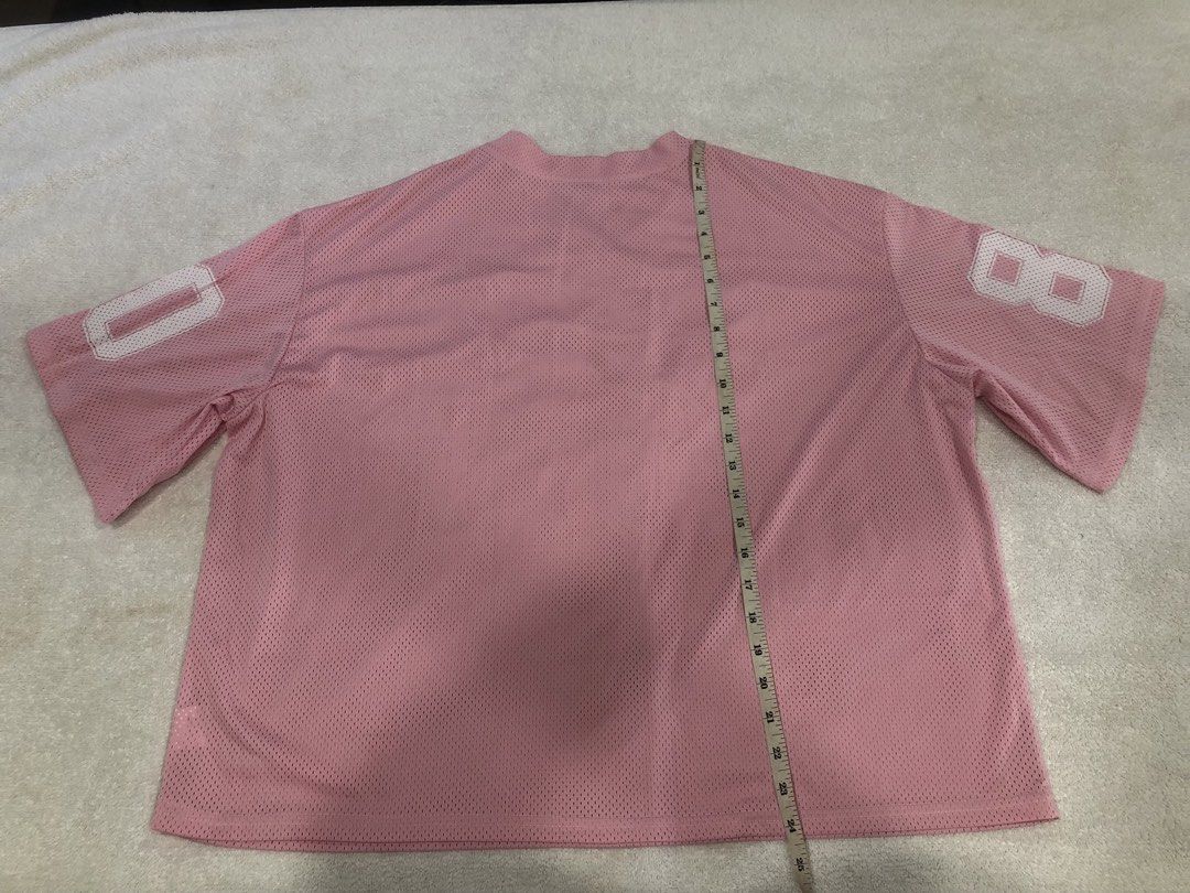 Pink "80" Jersey Top (Category: Shirts) located in Manila. Submitted by janmichael26601 (Listing ID 1461609502, Image 2). Description: - Pink mesh jersey - Features '80' graphic on front and sleeves - Short sleeves - V-neck design - Versatile for casual wear or costumes - Measurements: Pit to pit approx. 24 inches, Length approx. 28 inches.