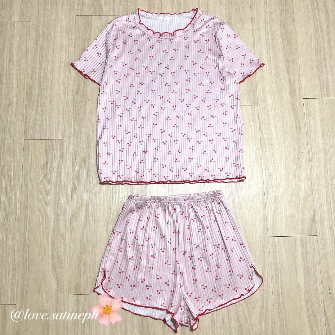 Pink Cherry Print Pajama Set with Ruffle Trim (Category: Undergarments & Loungewear) located in Manila. Submitted by love.satineph (Listing ID 1461605708, Image 1). Description: - Adorable pink pajama set with a fun cherry print. - Features a soft ribbed fabric texture. - Charming ruffled details on the neckline, sleeve trim, and shorts hem. - Comfortable elastic waistband for a perfect fit. - Ideal for cozy lounging at home..