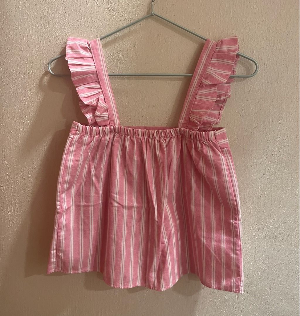 Pink Striped Ruffle Strap Top (Category: Sleeveless) located in Quezon City. Submitted by kiarampang60581 (Listing ID 1461731697, Image 2). Description: - Pink and white striped top - Features ruffle straps - Stylish tiered hem design - Elasticated back Feel free to message me for more details about the item! Loc: Culiat, Quezon City, Metro Manila MOP: GCash / BDO MOD: J&T / Grab / Lalamove.