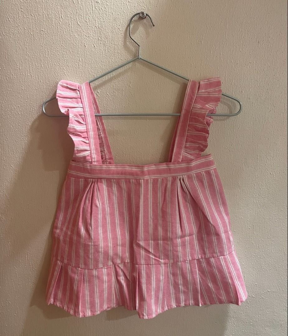 Pink Striped Ruffle Strap Top (Category: Sleeveless) located in Quezon City. Submitted by kiarampang60581 (Listing ID 1461731697, Image 1). Description: - Pink and white striped top - Features ruffle straps - Stylish tiered hem design - Elasticated back Feel free to message me for more details about the item! Loc: Culiat, Quezon City, Metro Manila MOP: GCash / BDO MOD: J&T / Grab / Lalamove.