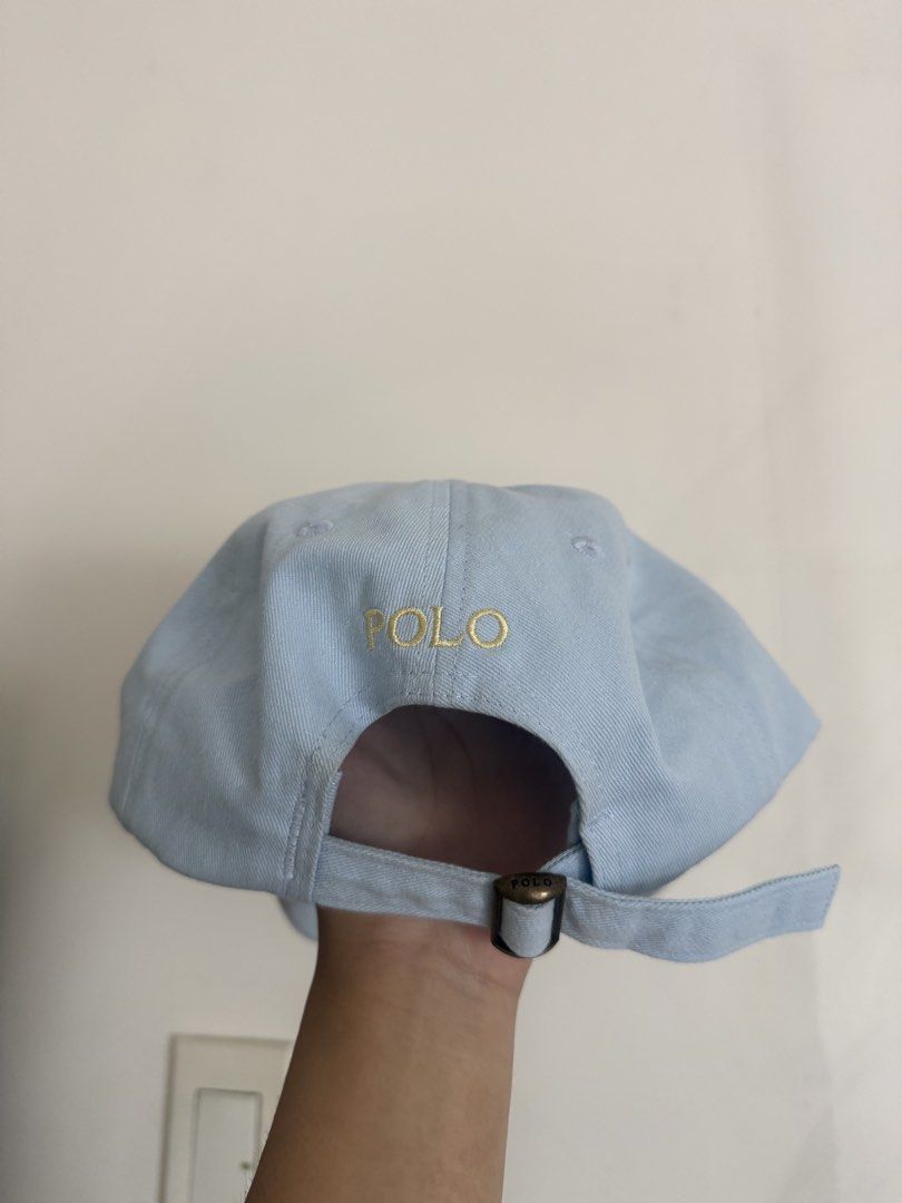 Polo Ralph Lauren Light Blue Cotton Cap (Category: Caps & Hats) located in Quezon City. Submitted by vynedeclutters (Listing ID 1461592738, Image 2). Description: - Light blue Polo Ralph Lauren cap - Iconic gold embroidered polo player logo on front - 'POLO' embroidered on the back - Adjustable strap for a comfortable fit - Made from 100% cotton.