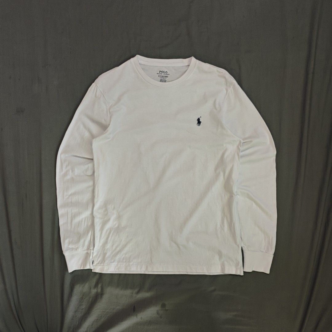Polo Ralph Lauren White Long Sleeve (Category: Tshirts & Polo Shirts ) located in Ipil. Submitted by ajthriftfinds (Listing ID 1461686319, Image 1). Description: - Dimes: 19x26 - As new condition - No issue - Brand: Polo Ralph Lauren - Features iconic navy pony logo on chest - Crew neck - Long sleeves - Versatile for layering or wearing on its own.
