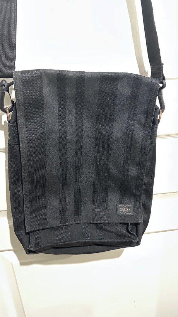 Porter Yoshida & Co. Black Striped Messenger Bag (Category: Sling Bags) located in Mandaluyong City. Submitted by TheWeekendProject (Listing ID 1461713781, Image 1). Description: - Brand: Porter Yoshida & Co. - Color: Black - Design: Subtle vertical stripe pattern - Compartments: Main compartment with internal pockets, zippered front pocket - Strap: Adjustable shoulder strap with padding (note: this is a replacement strap) - Use: Ideal for everyd