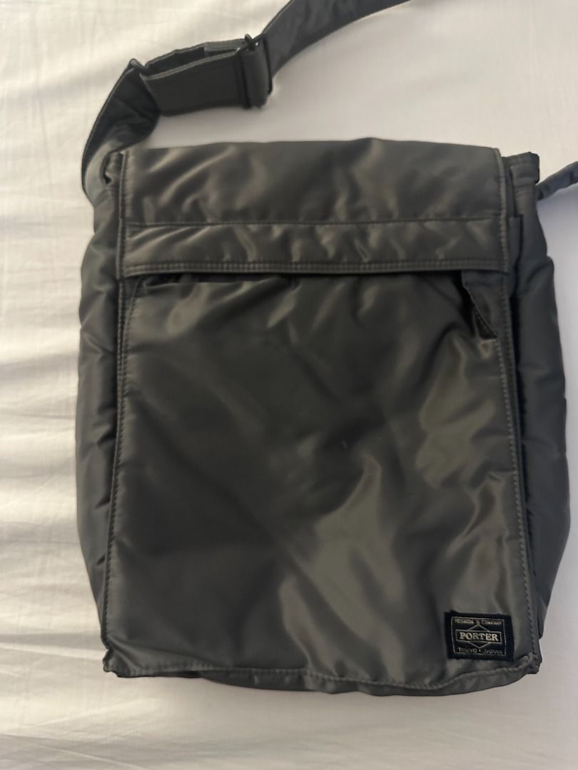 Porter Yoshida & Co. Nylon Messenger Bag (Category: Sling Bags) located in San Juan City. Submitted by looneyc (Listing ID 1461622195, Image 2). Description: - Grey Porter Yoshida & Co. messenger bag - Approximate dimensions: 12 inches tall x 10 inches wide - Made from durable nylon - Front flap with zippered pocket underneath - Adjustable shoulder strap for comfort - Ideal for daily use or travel - Ample space for essentials Just kept in storage