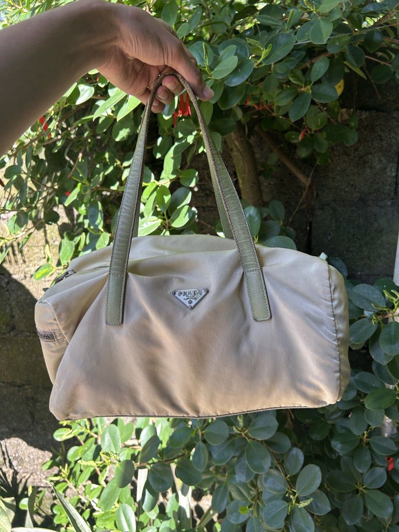 prada bag (Category: Shoulder Bags) located in San Antonio. Submitted by clinicallycute_. (Listing ID 1461626970, Image 1). Description: -Vintage Prada Boston Bag -Ivory/cream nylon with green leather handles -Made in Italy -With original tag + No. 8 tag -Condition: Good vintage condition -Issues: visible yellowing/discoloration on nylon + wear/darkening on leather handles/edges -Price: ₱13,500 negotiable -Selling as-is; please see photos for con