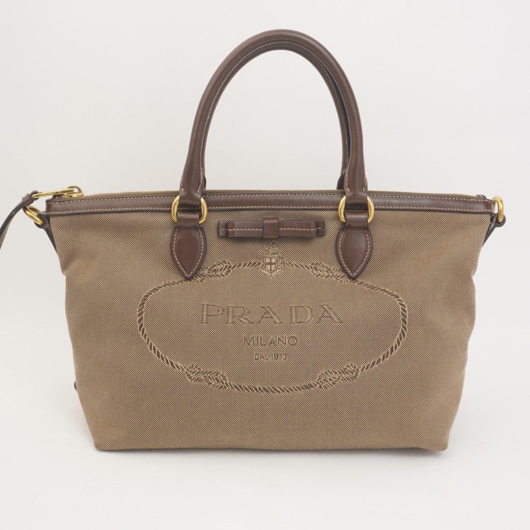 Prada Brown Jacquard Bow Two Way (Category: Luxury Bags & Wallets) located in Taguig. Submitted by dluxenest (Listing ID 1461630833, Image 2). Description: Last price posted Inclusion: strap, identification card, guarantee card, clochette You may follow us on IG : dluxenest FB : Dragons Luxe Nest.