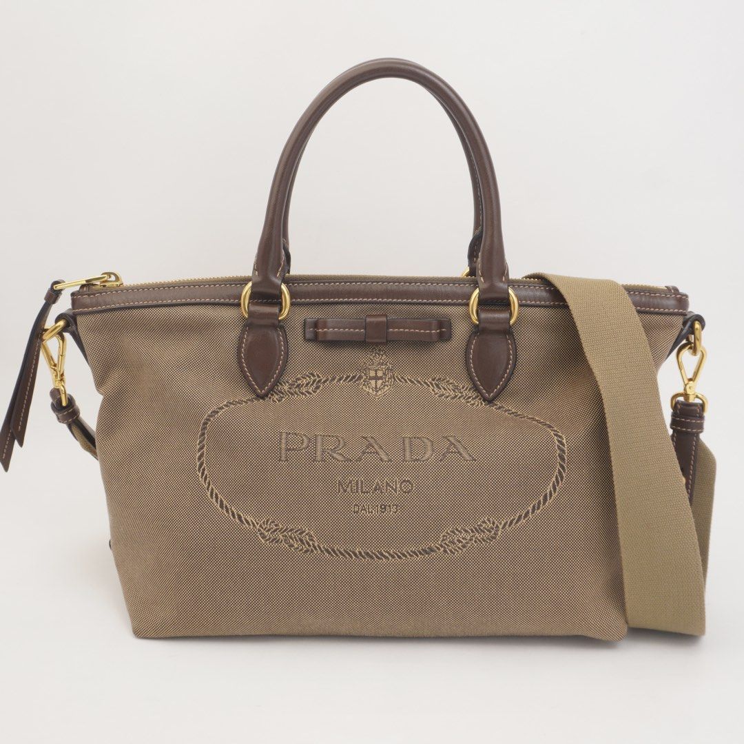 Prada Brown Jacquard Bow Two Way (Category: Luxury Bags & Wallets) located in Taguig. Submitted by dluxenest (Listing ID 1461630833, Image 1). Description: Last price posted Inclusion: strap, identification card, guarantee card, clochette You may follow us on IG : dluxenest FB : Dragons Luxe Nest.
