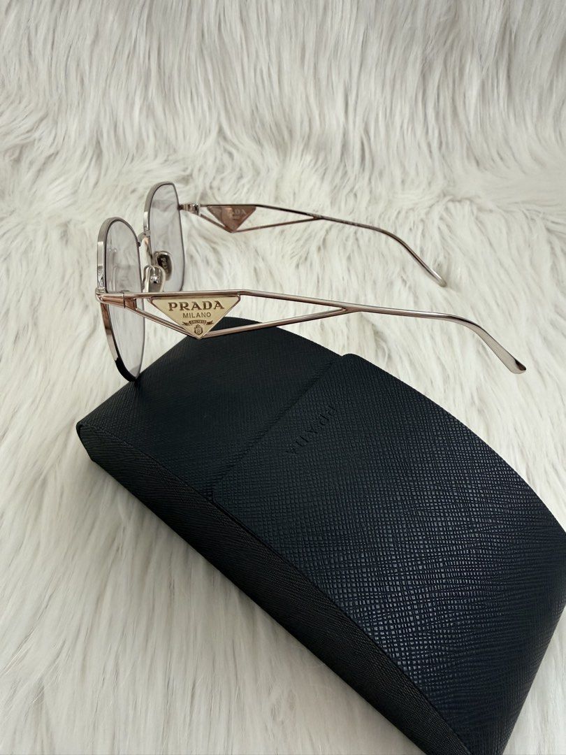 Prada Milano Eyeglasses with Case (Category: Sunglasses & Eyewear) located in Cainta. Submitted by mskath__ (Listing ID 1461656245, Image 3). Description: - Authentic Prada eyeglasses - Silver-tone metal frame - Clear lenses - Iconic Prada triangle logo on temples - Comes with original Prada hard case - Perfect for daily wear or as a fashion statement.