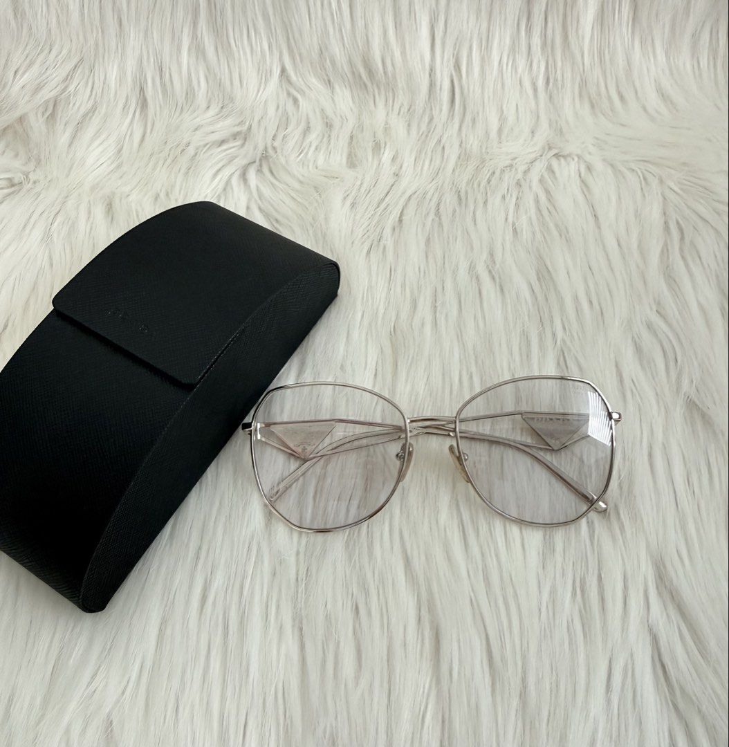 Prada Milano Eyeglasses with Case (Category: Sunglasses & Eyewear) located in Cainta. Submitted by mskath__ (Listing ID 1461656245, Image 1). Description: - Authentic Prada eyeglasses - Silver-tone metal frame - Clear lenses - Iconic Prada triangle logo on temples - Comes with original Prada hard case - Perfect for daily wear or as a fashion statement.