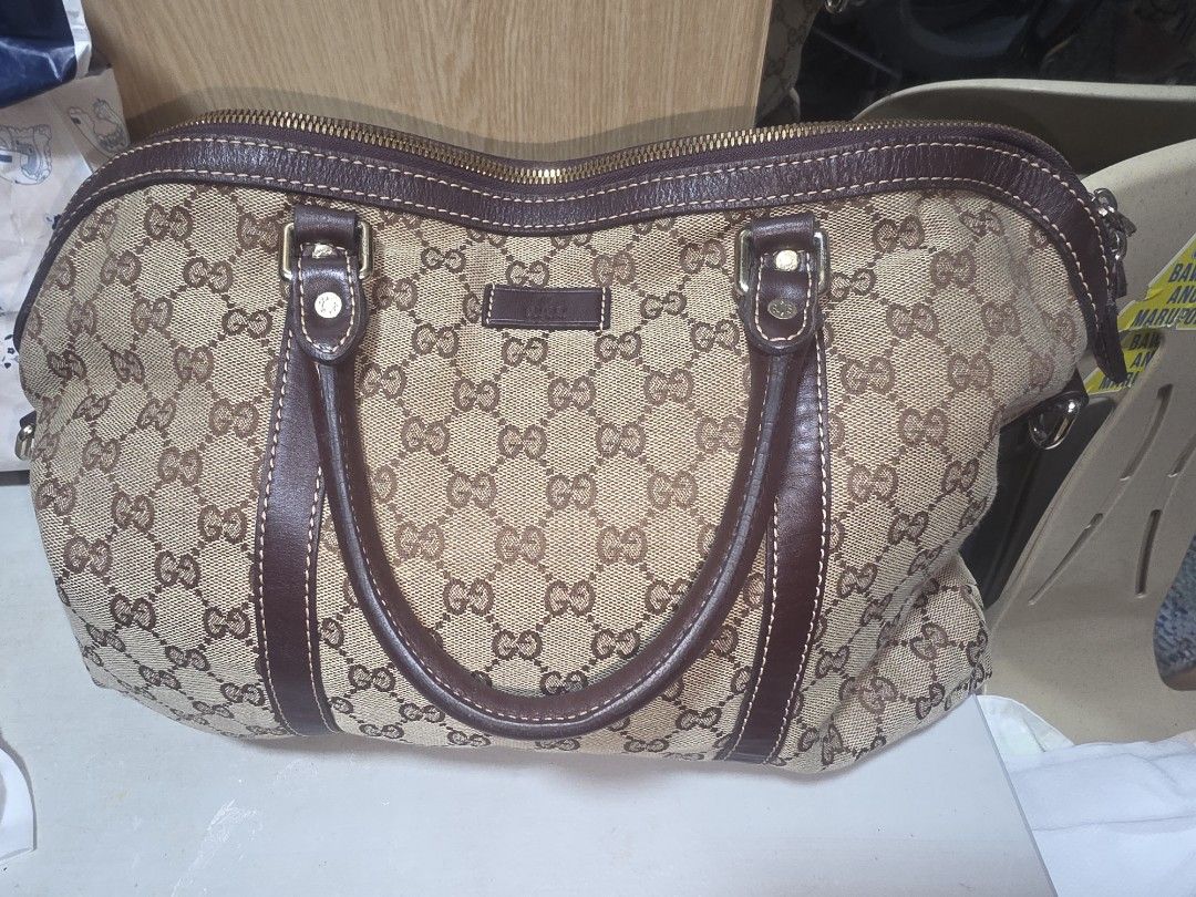 PRE-LOVED GUCCI GG MONOGRAM BAG (Category: Luxury Bags & Wallets) located in Manila. Submitted by yammm23 (Listing ID 1461642520, Image 1). Description: PRE-LOVED GUCCI GG MONOGRAM TOP-HANDLE BAG — BROWN ✨ DETAILS: 👍Classic GG monogram canvas exterior 👍Rich dark brown leather handles and trims 👍Double top handles for comfortable hand or arm carry 👍Full-length zipper closure 👍Gold-tone hardware 👍Spacious interior suitable for daily essential