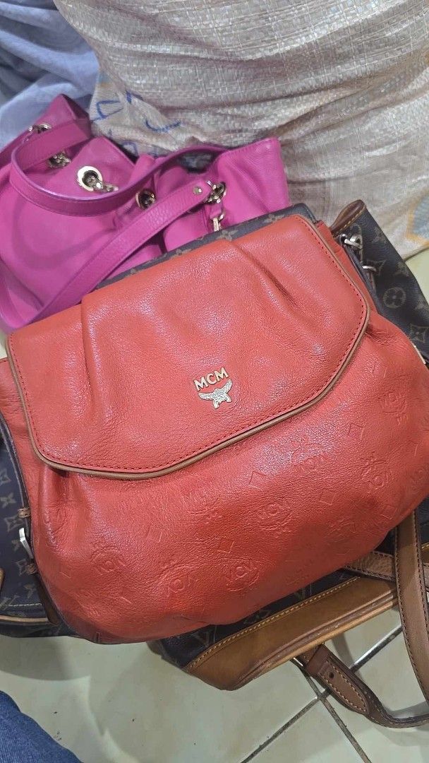 Preloved MCM Shoulder Bag Orange Leather Monogram (Category: Luxury Bags & Wallets) located in Quezon City. Submitted by mbpreloved65 (Listing ID 1461579161, Image 2). Description: - Authentic Orange MCM Shoulder Bag - Signature all-over monogram pattern - Genuine leather with gold hardware details - Features an interior zip pocket - Adjustable strap for comfortable wear - Selling Price: P1700 (Original Price: P2500).