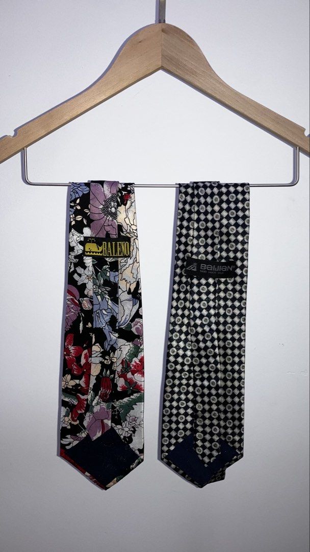 Preloved Silk Tie (Category: Ties) located in Kuala Lumpur. Submitted by buenning_41 (Listing ID 1461750708, Image 2). Description: - Set of 2 standard width neckties - Baleno tie: Black background with colorful floral print - Benjien tie: Black and silver geometric pattern - Versatile for both formal and casual occasions.