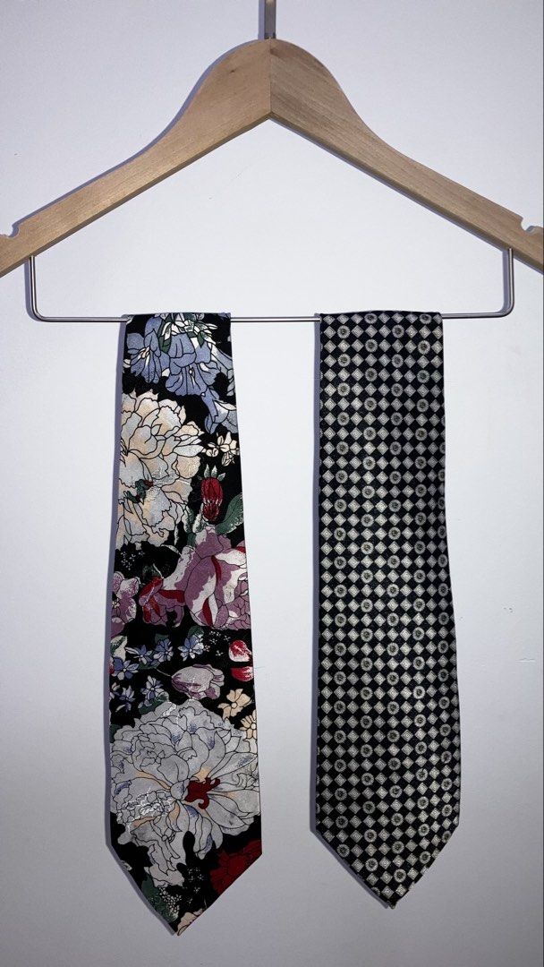 Preloved Silk Tie (Category: Ties) located in Kuala Lumpur. Submitted by buenning_41 (Listing ID 1461750708, Image 1). Description: - Set of 2 standard width neckties - Baleno tie: Black background with colorful floral print - Benjien tie: Black and silver geometric pattern - Versatile for both formal and casual occasions.