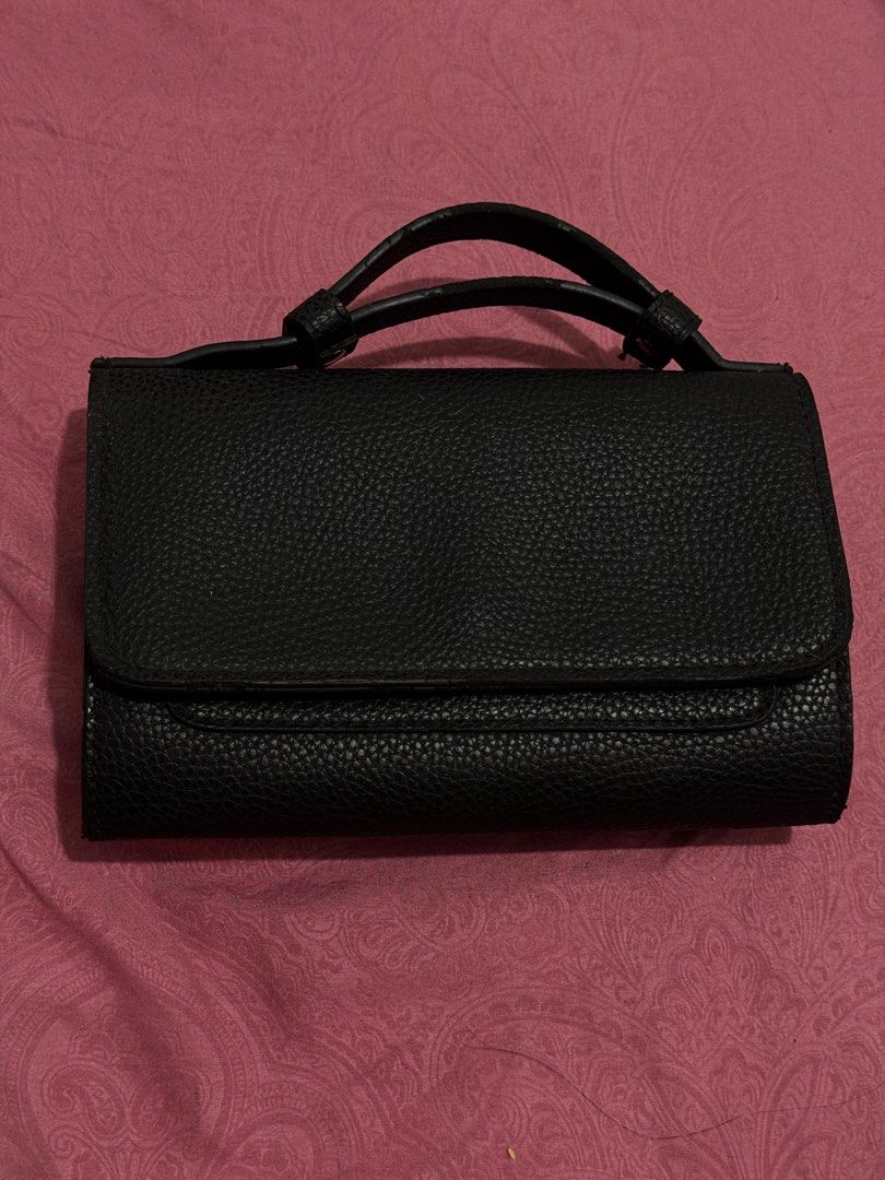 Primadonna Black Textured Handbag with Snap Closure (Category: Luxury Bags & Wallets) located in Bauang. Submitted by jeneefromtheblock (Listing ID 1461772269, Image 2). Description: - Brand: Primadonna - Color: Black - Material: Textured - Closure: Front flap with two snap closures - Interior: Multiple compartments - Handles: Top handles - Size: Small and compact - Ideal for: Carrying essentials.