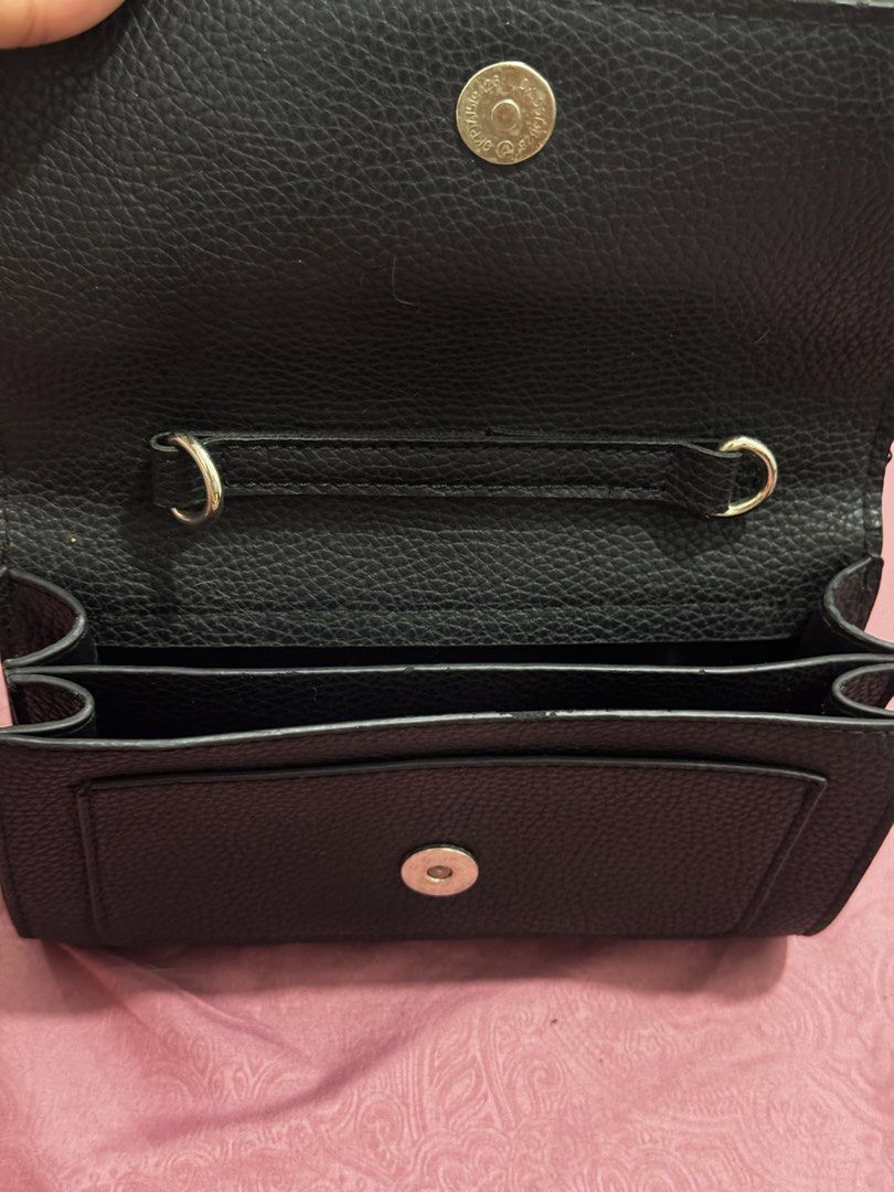 Primadonna Black Textured Handbag with Snap Closure (Category: Luxury Bags & Wallets) located in Bauang. Submitted by jeneefromtheblock (Listing ID 1461772269, Image 3). Description: - Brand: Primadonna - Color: Black - Material: Textured - Closure: Front flap with two snap closures - Interior: Multiple compartments - Handles: Top handles - Size: Small and compact - Ideal for: Carrying essentials.