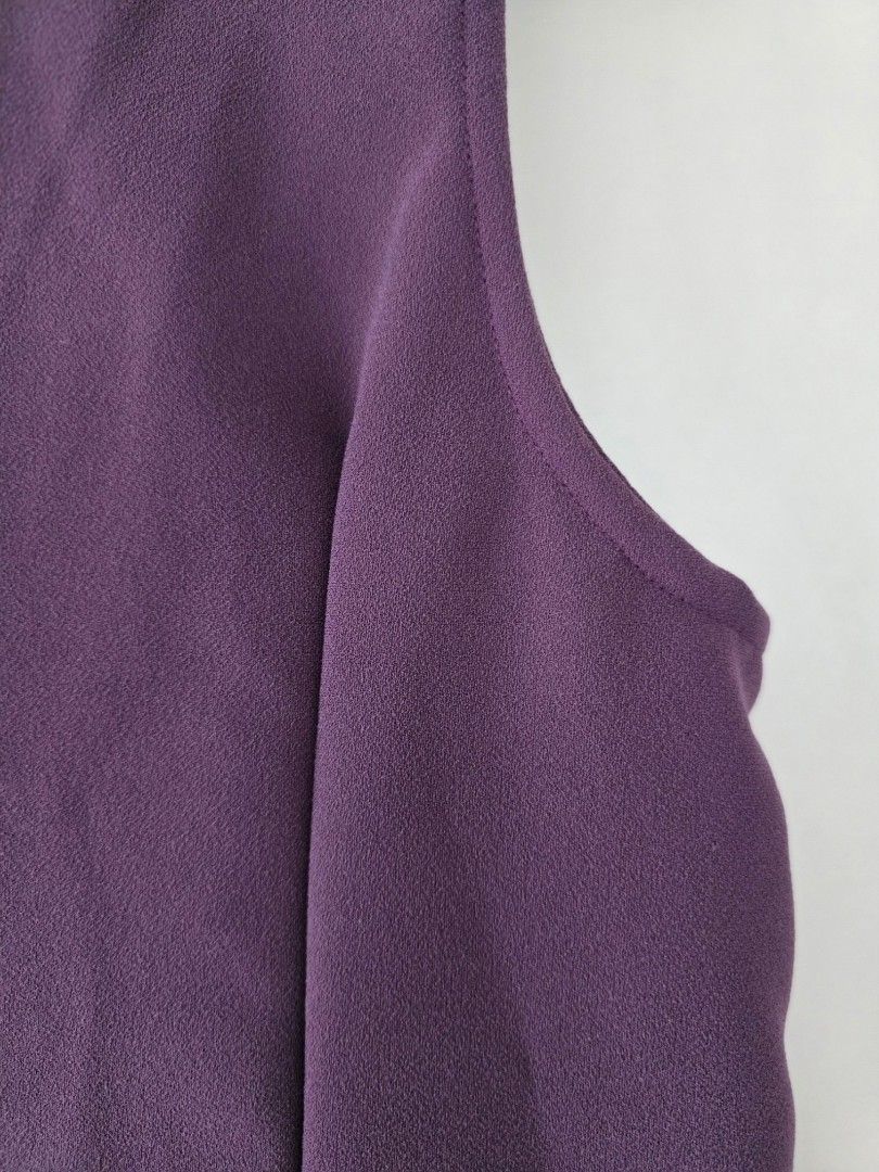 Purple Button-Up Sleeveless Vest (Category: Sleeveless) located in Cainta. Submitted by piper8 (Listing ID 1461580200, Image 3). Description: -Dimensions laid flat: Legth: 56 cm chest: 46 cm sleeve hole: 22 cm - Deep purple sleeveless vest - Round neckline - Button-up front with 4 matching buttons - Unique curved hemline - Subtle textured fabric finish - Ideal for layering over any outfit.