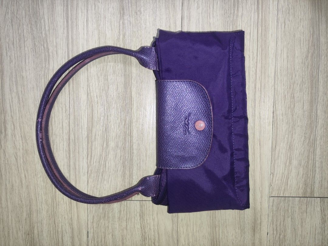 Purple Longchamp Style Nylon Bag Organizer Insert (Category: Purses & Pouches) located in Quezon City. Submitted by mightyowl_2ccc44 (Listing ID 1461572351, Image 1). Description: - Purple nylon bag organizer with elegant leather trim. - Multiple pockets and a zippered compartment for secure storage. - Keeps your essentials neatly organized and easy to find. - Soft, light beige felt interior lining. - Designed to fit perfectly inside larger tote 