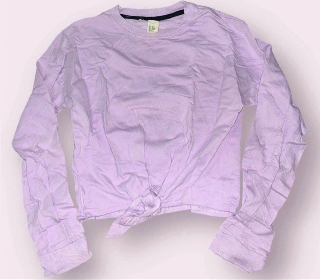 Purple Tie Up Sweater Pullover 11-12yo (Category: Babies & Kids Fashion) located in Rizal. Submitted by cassappl (Listing ID 1461682551, Image 1). Description: - Light purple long sleeve top - Tie front detail at the hem - Crew neck with black trim inside - Ideal for casual outfits or layering.