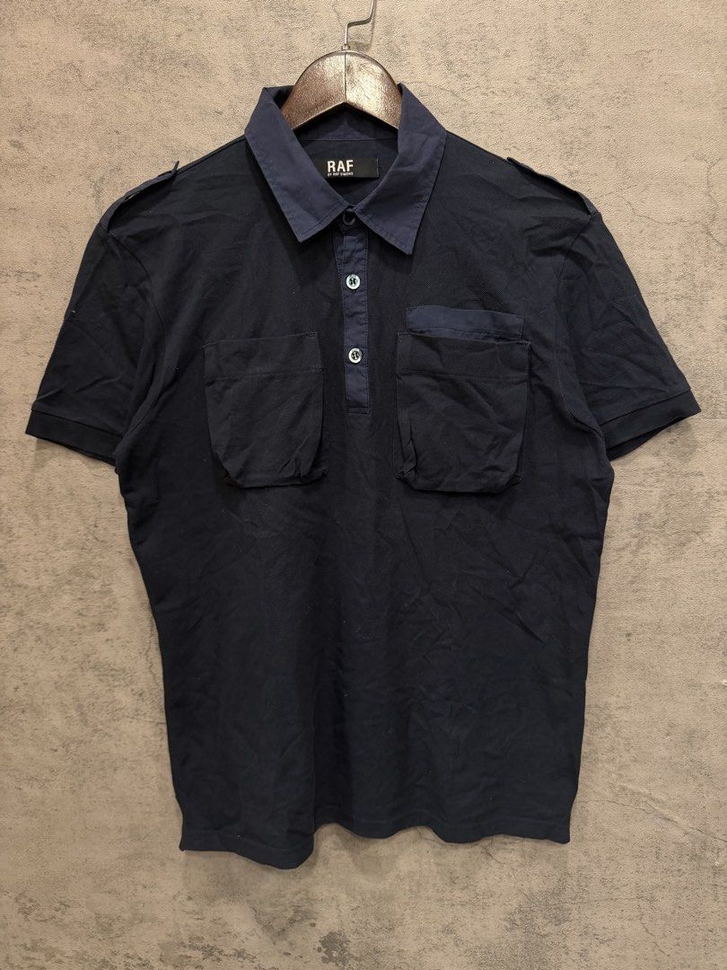 RAF SIMONS (Category: Tshirts & Polo Shirts ) located in Quezon City. Submitted by macleen17 (Listing ID 1461692924, Image 1). Description: RAF SIMONS Size M Excellent Condition Navy blue Color Two pockets in front RAF design in buttons Made in portugal.