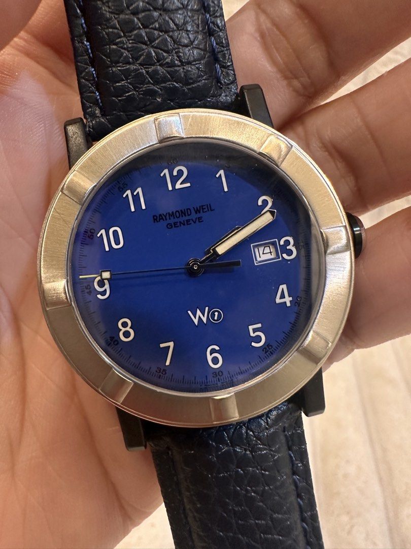 Raymond Weil W1 Parsifal (Ref. 6100) (Category: Luxury Watches) located in Pasig City. Submitted by surplusatbp (Listing ID 1461569279, Image 3). Description: Raymond Weil W1 Parsifal (Ref. 6100) Description: Authentic vintage Swiss quartz sport watch from Raymond Weil’s iconic W1 series, featuring a striking blue dial with the signature W1 logo and a rugged composite-steel case construction. Case Size: 41.1 mm | Wrist Size: Fits up to 18 cm Feat