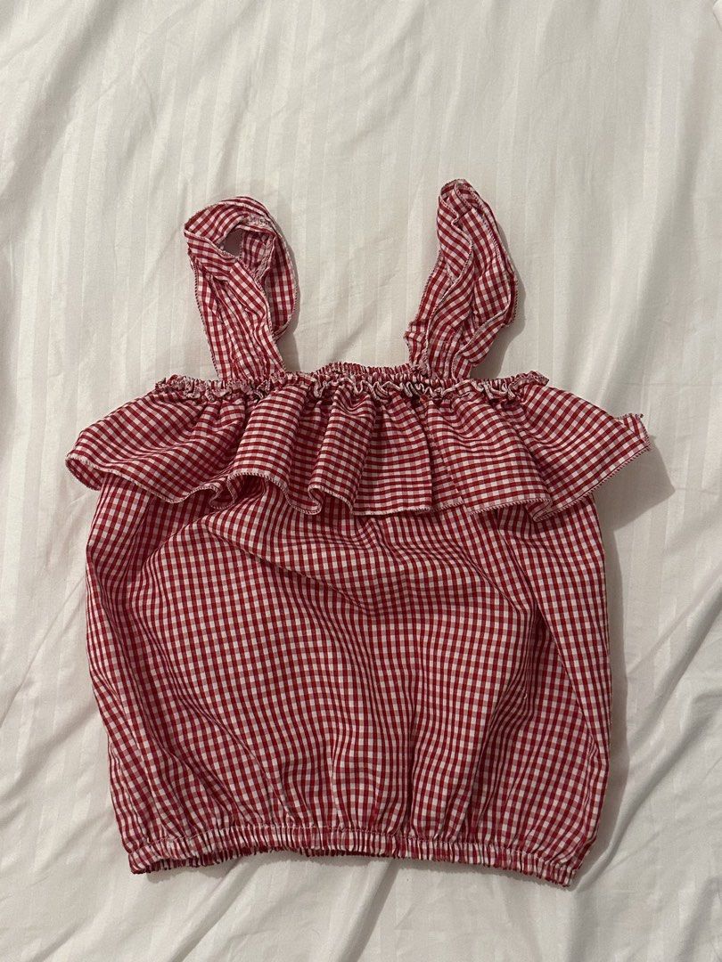 Red Gingham Ruffle Crop Top with Tie Straps (Category: Sleeveless) located in Santo Tomas. Submitted by prelovedspacesbyji (Listing ID 1461760576, Image 1). Description: - Adorable red and white gingham pattern - Ruffled neckline for a feminine touch - Comfortable elasticated hem - Can be worn on or off the shoulder - Ideal for summer outings and casual wear.