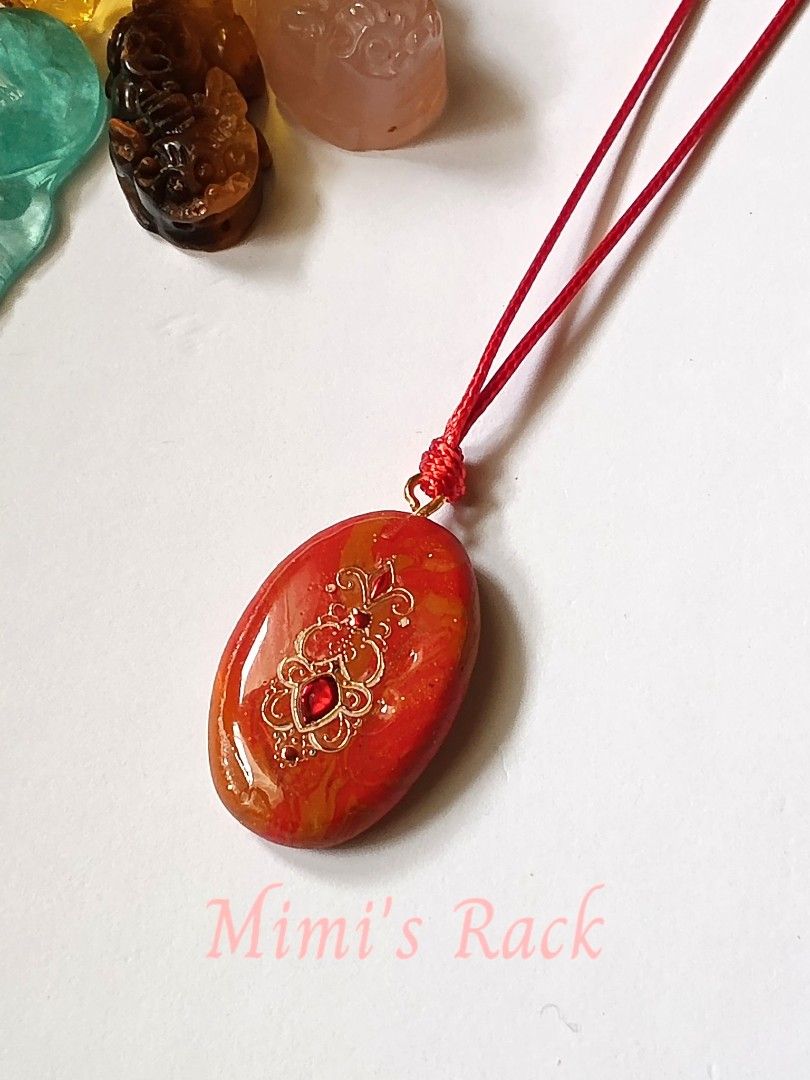 Red Orange Decoupage Rope Necklace (Category: Necklaces) located in Taguig. Submitted by mimisrack (Listing ID 1461626419, Image 2). Description: ❤️Beautiful red-orange decoupage pendant necklace with a glossy, polished finish and an elegant gold-tone decorative design. -The warm red and orange tones blend beautifully, giving the pendant a vibrant and eye-catching look. ✨ -The pendant features an ornate floral-style motif with a small sparkling r
