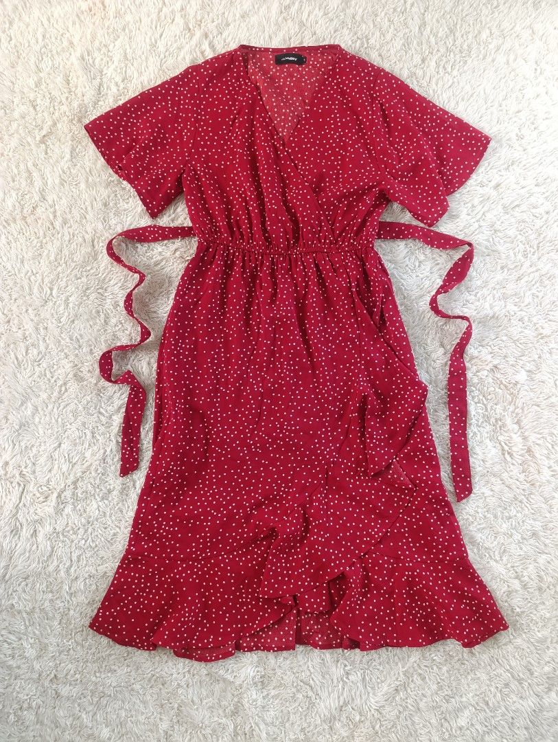 Red Polka Dot Wrap Dress with Ruffle Hem (Category: Dresses) located in Bocaue. Submitted by tacobellaaa (Listing ID 1461642269, Image 1). Description: - fits S- semi Large -Good as New - Comfortable elasticated waist with a matching tie belt. - Charming ruffle detail along the hemline. - Flattering short flutter sleeves. - Ideal for casual outings, brunches, or a fun day out!.