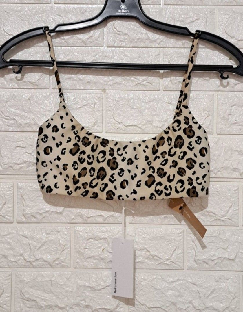 Reformation Malibu Bikini Top No Pads! (Category: Activewear) located in Taguig. Submitted by authprelovedonlineshop2 (Listing ID 1461696305, Image 2). Description: - Reformation Malibu Bikini Top - Size: XS - Print: Feline (leopard) - Features: Square neckline, thin straps - Color: Beige background with brown and black spots - No pads! - Condition: New with tags - Php1,488 🍀All items are preloved unless stated as brand new. 🍀Please manage your