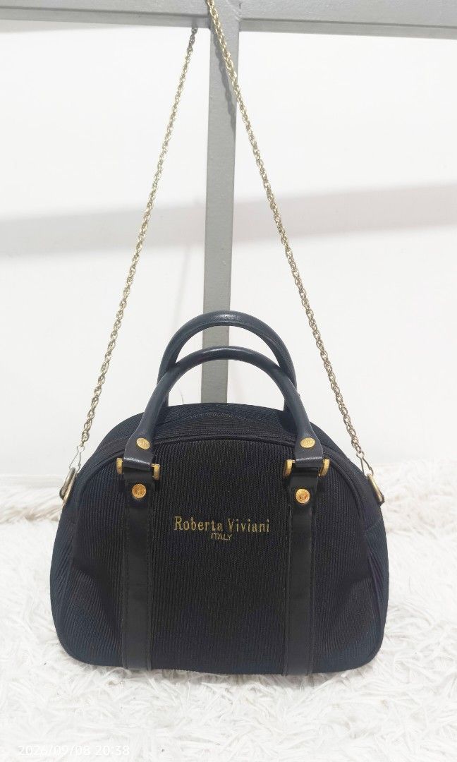 ROBERTA VIVIANI ITALY SHOULDER BAG (Category: Cross-body Bags) located in Kalibo. Submitted by secondchances.thriftsh8p (Listing ID 1460450253, Image 1). Description: - Authentic Roberta Viviani handbag from Italy - Elegant dome shape - Textured material with luxurious leather trim - Chic gold hardware details - Includes a detachable gold chain strap for versatile styling - Clean and well-maintained interior - Ideal for both daytime and evening o