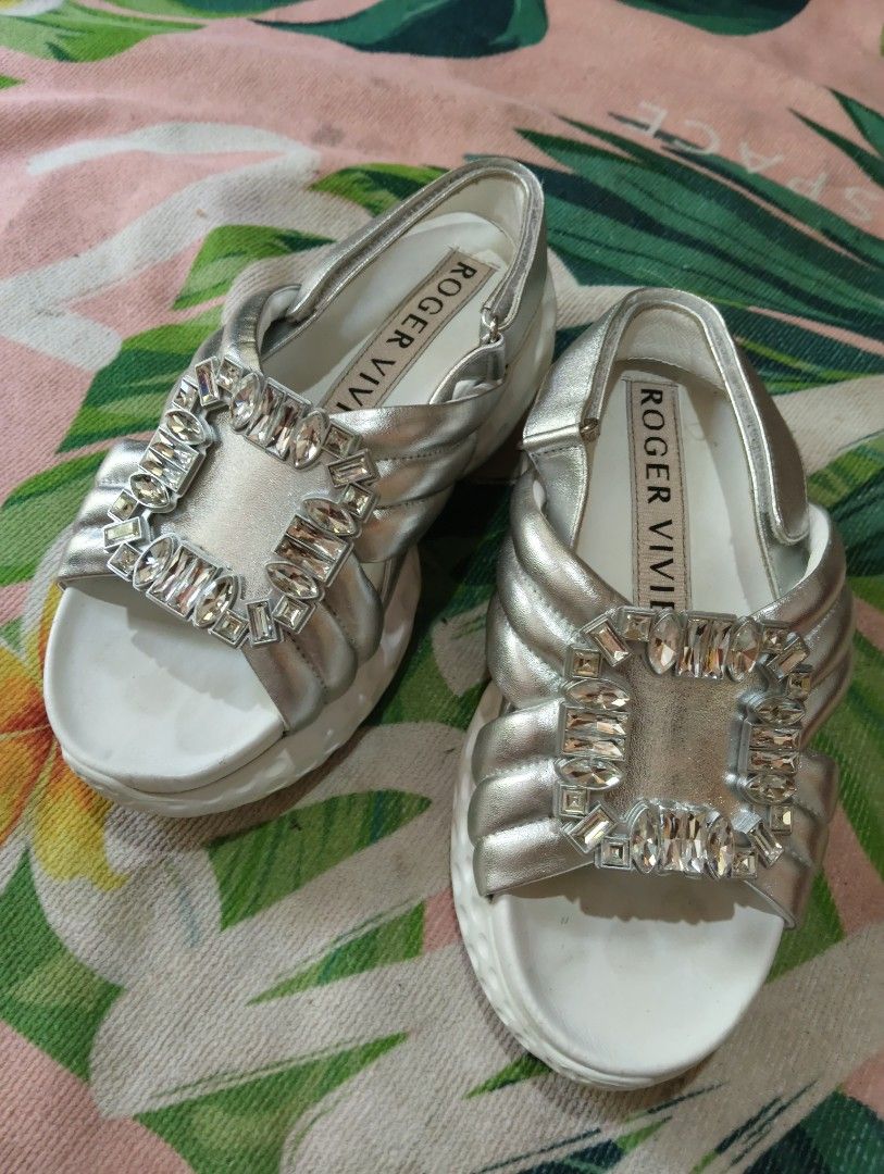 Roger Vivier Silver Crystal Buckle Slingback Sandals (Category: Flats & Sandals) located in Davao. Submitted by noelamihan05424 (Listing ID 1461570428, Image 1). Description: - Authentic Roger Vivier silver sandals - Iconic crystal buckle detail - Secure and comfortable slingback strap - Padded straps and sole for all-day comfort - Versatile: dress up or down - Comes with original box -23.5 cm on tape - No issue .