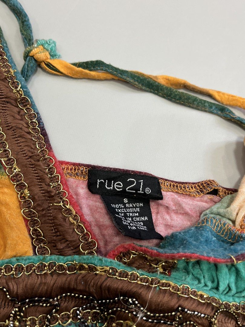 Rue 21 Tie Dye Tank Top Size S (Category: Sleeveless) located in Mabalacat. Submitted by aas_thriftfings (Listing ID 1461586408, Image 3). Description: - Cute Rue 21 tank top - Vibrant tie-dye pattern in yellow, green, red, and blue - Features delicate beaded trim detail - Adjustable straps for a perfect fit - Made from comfortable 100% rayon - Ideal for casual everyday wear.