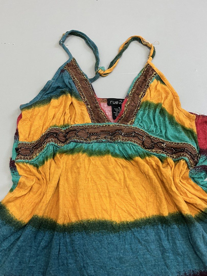 Rue 21 Tie Dye Tank Top Size S (Category: Sleeveless) located in Mabalacat. Submitted by aas_thriftfings (Listing ID 1461586408, Image 2). Description: - Cute Rue 21 tank top - Vibrant tie-dye pattern in yellow, green, red, and blue - Features delicate beaded trim detail - Adjustable straps for a perfect fit - Made from comfortable 100% rayon - Ideal for casual everyday wear.