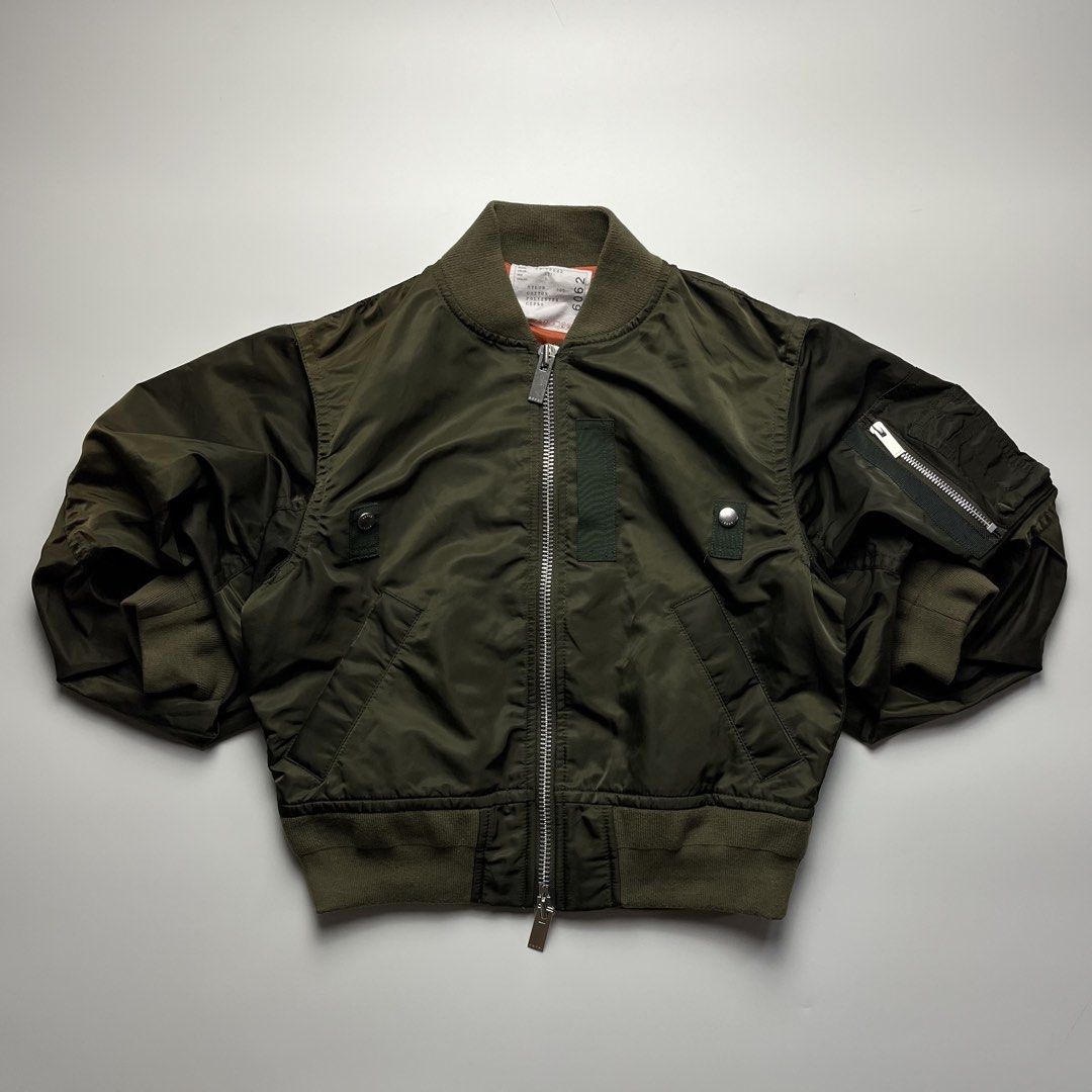 Sacai 22SS Nylon Twill Cropped Puff Bomber Jacket (Category: Luxury Apparel) located in Manila. Submitted by streetsavvy (Listing ID 1461679400, Image 1). Description: Sacai 22SS Nylon Twill Cropped Puff Bomber Jacket Size: 1 Width: 20” Length: 20” Shoulder: 17” Sleeve Length: 14” Hem: 15” Measured in Inches iconic piece from Sacai’s Spring/Summer 2022 collection. This piece features Chitose Abe’s signature hybrid design, combining classic MA-1 m