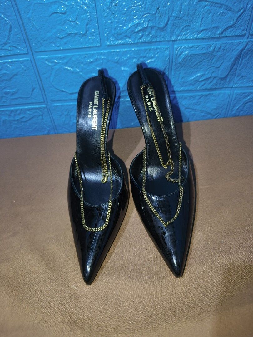Saint Laurent Black Patent Chain Slingback Heels (Category: Heels) located in Davao. Submitted by vndrgd (Listing ID 1461706135, Image 2). Description: - Brand: Saint Laurent - Material: Black patent leather - Style: Slingback heels - Features: Pointed toe, gold chain detailing on front and ankle strap - Heel: High stiletto - Occasion: Perfect for dressing up any outfit, very chic and stylish.