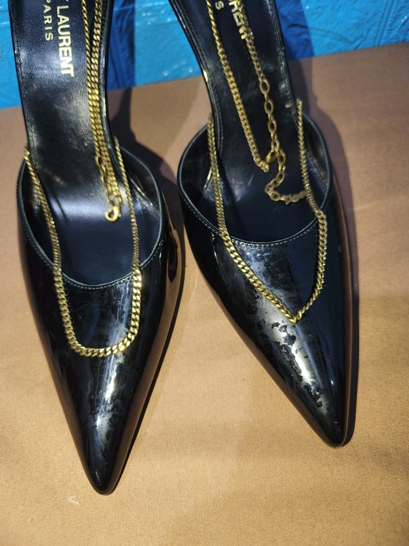 Saint Laurent Black Patent Chain Slingback Heels (Category: Heels) located in Davao. Submitted by vndrgd (Listing ID 1461706135, Image 3). Description: - Brand: Saint Laurent - Material: Black patent leather - Style: Slingback heels - Features: Pointed toe, gold chain detailing on front and ankle strap - Heel: High stiletto - Occasion: Perfect for dressing up any outfit, very chic and stylish.