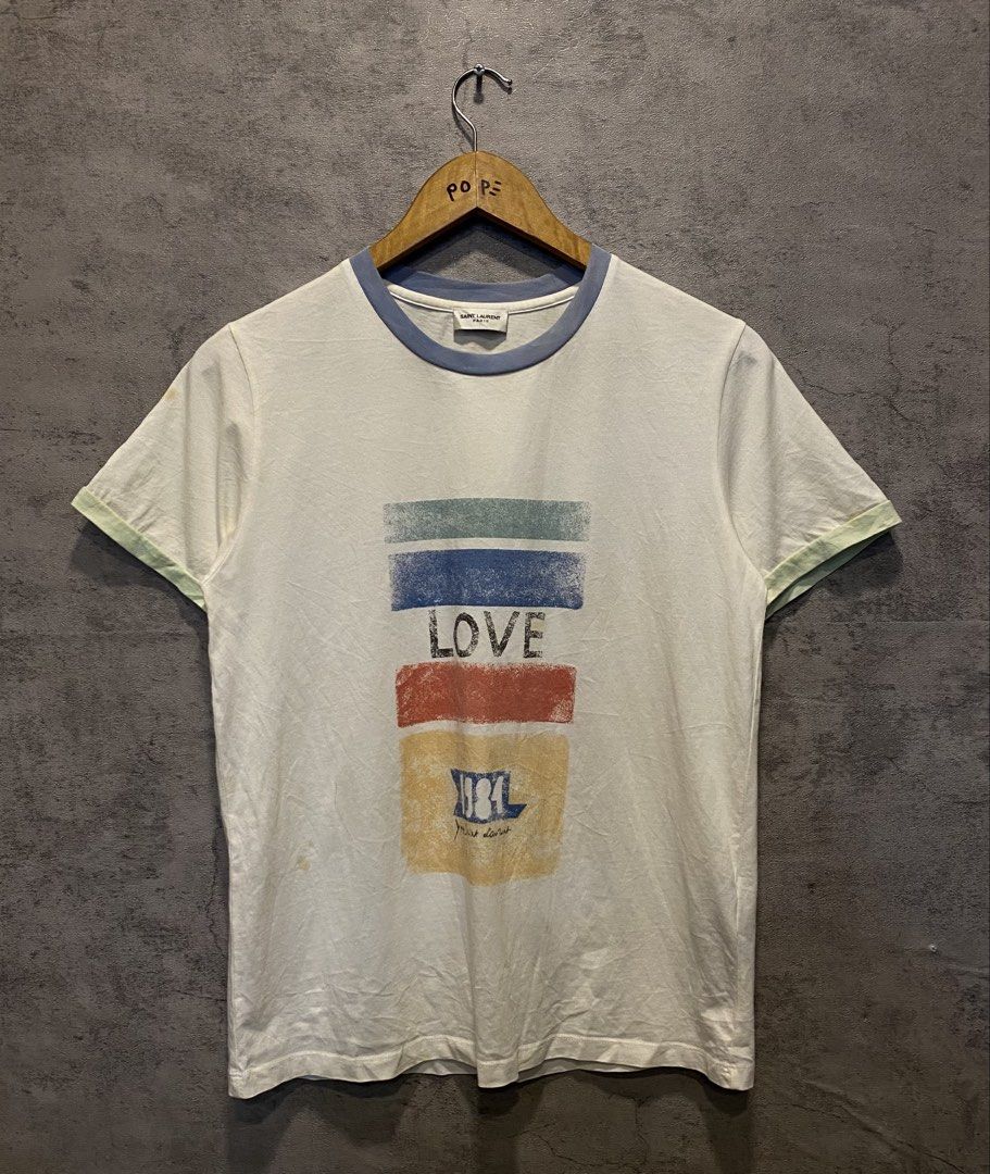 Saint Laurent Paris "1984" Tee (Category: Luxury Apparel) located in Quezon City. Submitted by rebirthalley (Listing ID 1461636124, Image 2). Description: Width-18 Length-25 Sleeve-7 Shoulder-15 Hem-18 Very Good Condition Need Wash Yellow Stains.
