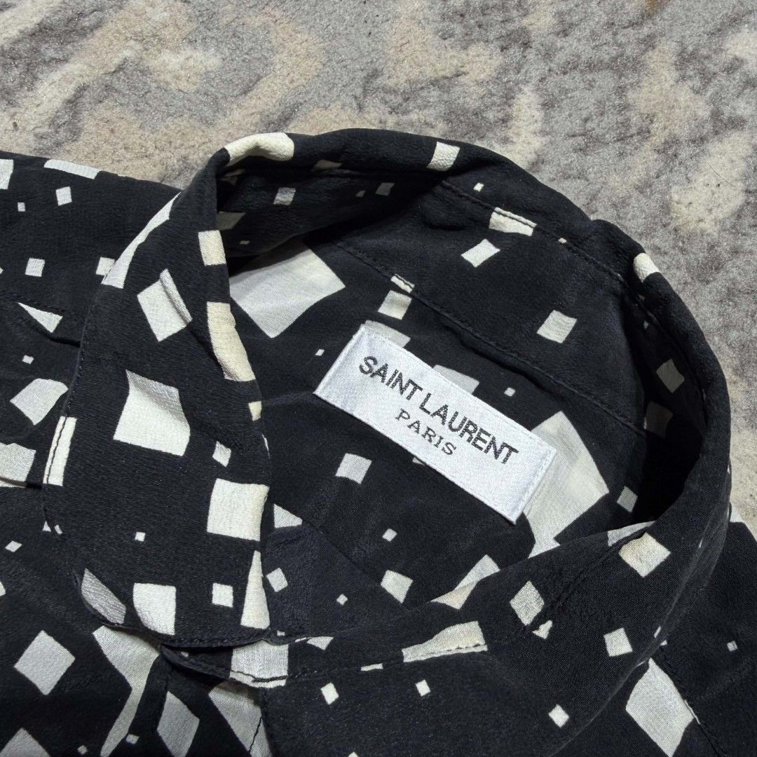 Saint Laurent Paris Square-Print Silk Shirt (Category: Luxury Apparel) located in Dagupan City. Submitted by kiroshi12 (Listing ID 1461634364, Image 2). Description: - Authentic Classic Saint Laurent Paris shirt - Color: Black with white geometric square print - Material: 100% Silk - Origin: Made in Italy - Style: Button-up with collar - Versatile: Perfect for dressing up or down.