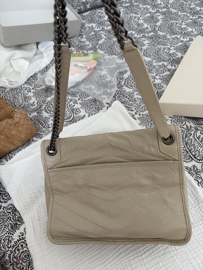 Saint Laurent YSL Monogram Chain Bag Beige Leather (Category: Luxury Bags & Wallets) located in Taguig. Submitted by katdcp (Listing ID 1461579627, Image 3). Description: - Elegant beige YSL chain bag - Features classic chevron quilting on the front flap - Prominent YSL logo in the center - Includes a practical front pocket and a back pocket - Stylish dark grey metal chain strap - Versatile for everyday use or nights out.