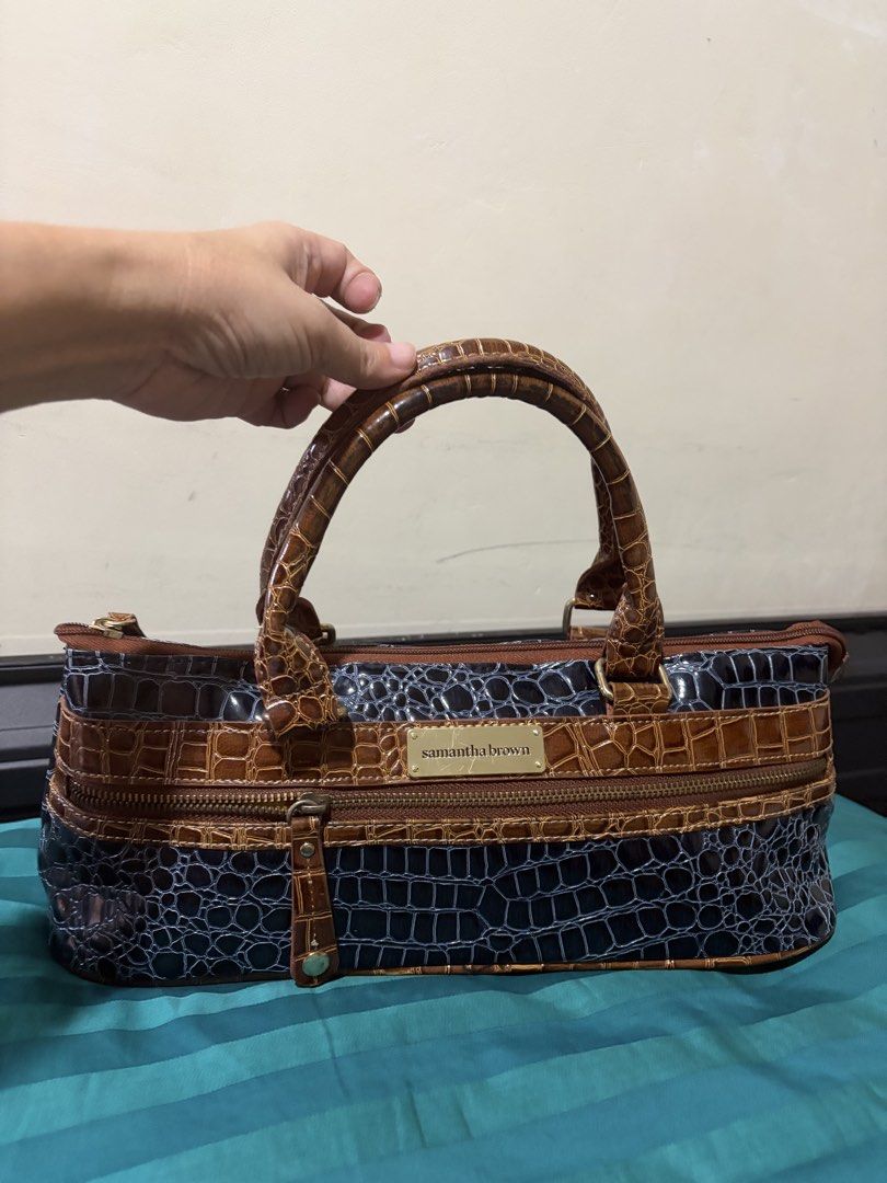 Samantha Brown Crocodile Pattern Bag (Category: Shoulder Bags) located in Las Pinas. Submitted by ces0427 (Listing ID 1461657249, Image 2). Description: - Stylish Samantha Brown bag - Unique crocodile pattern - Colorblock design: brown and dark blue sections - Textured brown handles - Silver interior lining - NO FLAW looks good as new - Secure all-around zip closure - Ideal for carrying your daily essentials.